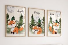 two framed pictures on the wall of a bedroom with fox and pine trees in front of them