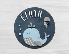 a sign that says ethan with a whale and jellyfish