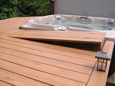 a hot tub sitting on top of a wooden deck