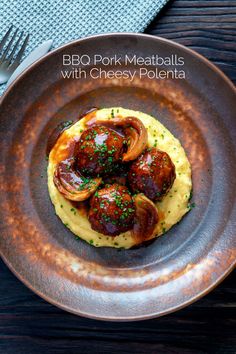 a plate with some meatballs and mashed potatoes on it