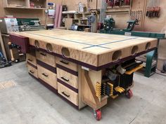 a workbench with many drawers and tools on it