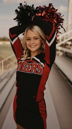 a cheerleader is posing on the bleachers