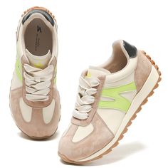 a pair of beige sneakers with green accents