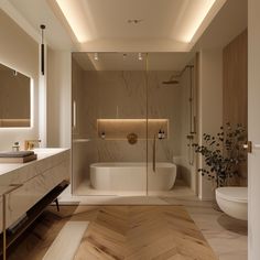 a modern bathroom with wood flooring and white walls, along with a large mirror on the wall