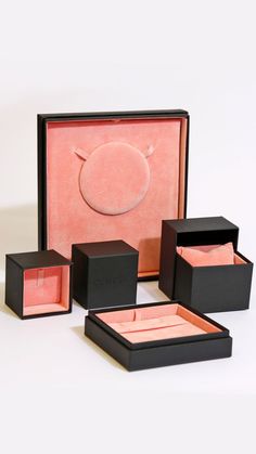 an assortment of black and pink jewelry boxes