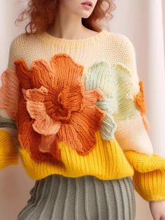 a woman wearing a sweater with flowers on it