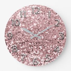 a pink clock with silver numbers on it