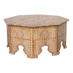 an intricately carved wooden table on white background