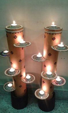 several candles are lit on top of each other