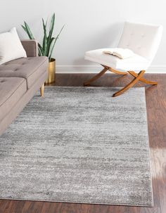 a living room with a couch, chair and rug