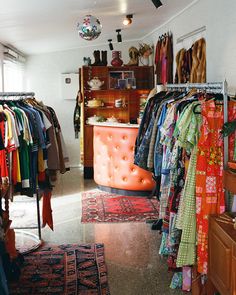 a room filled with lots of clothes and rugs