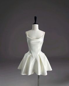 a white dress on a mannequin stand