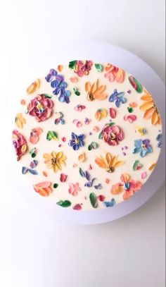 a cake decorated with flowers on a white plate