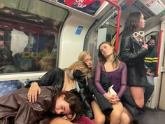 three young women are sleeping on the subway