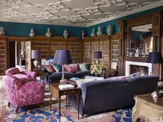 a living room filled with furniture and lots of books