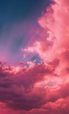 the sky is filled with pink clouds and stars