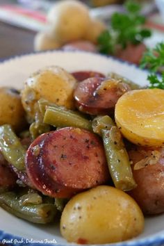 a close up of a plate of food with potatoes and green beans on the side