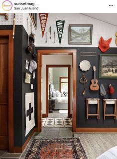 the hallway is decorated with pictures and other items on the wall, along with an area rug