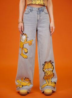 Get cat walk ready with these Garfield denim pants! They have a light wash and wide leg silhouette. Bursting with cat-titude  these pants feature Garfield printed on the legs in various poses. Comes with classic 5-pocket styling. Garfield Pjs, Garfield Outfit, Garfield Aesthetic, Tiktok Aesthetics, Garfield Costume, Artsy Clothes, Barista Outfits, Dream Inspiration, Wide Leg Denim Pants