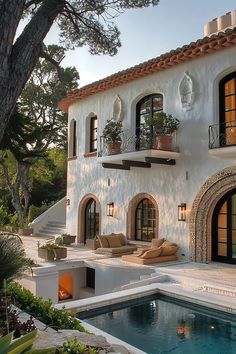 a house with a pool in front of it and lots of windows on the side