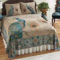 a bed with blue and white pillows on top of it next to a chair in front of a window