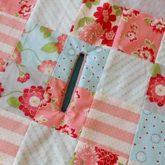 a patchwork quilt with flowers and stripes