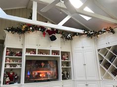 the entertainment center is decorated for christmas with stockings and stocking hanging from the ceiling