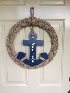 a wreath with an anchor hanging on the front door