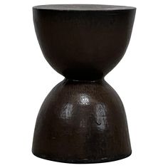 a black vase sitting on top of a table