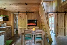 a dining room table with chairs and a fire place