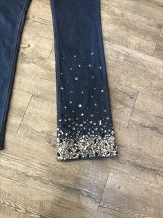 a pair of jeans with silver sequins on them