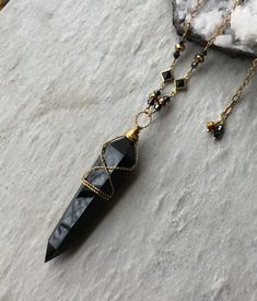 2" long (without the bail) polished black obsidian crystal point, Czech crystals, brass crystal connectors, natural brass chain and lobster clasp. This necklace is adjustable from 24-26" long. To keep the new brass look, clean with brass cleaner or dip in jewelry cleaning solution when needed. ~Visit our new shop Free Spirit Rox for beautiful collectible crystals, gemstones and mineral specimens! https://www.etsy.com/shop/FreeSpiritRox Obsidian Necklace And Earring, Black Agate Crystal Necklace For Healing, Healing Black Agate Crystal Necklaces, Black Obsidian Amulet Necklaces, Black Obsidian Amulet Necklace, Black Obsidian Necklaces For Jewelry Making, Black Pendant Crystal Necklaces For Meditation, Black Crystal Pendant Necklaces For Meditation, Black Agate Spiritual Necklace