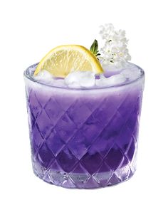 a purple drink with ice and lemon wedges on the rim, garnished with white flowers