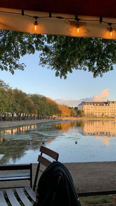 a person sitting on a bench looking at the water