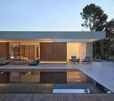 an outdoor living area with wooden floors and furniture