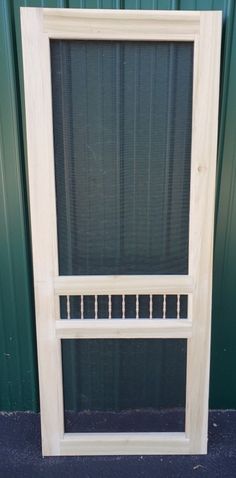 a white window sitting on top of a blue floor next to a green metal wall