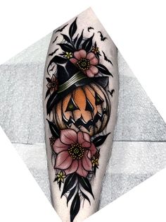 a tattoo with flowers and a pumpkin on it