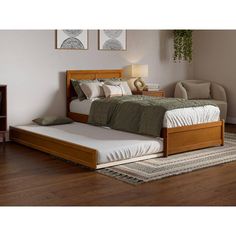 a bed sitting on top of a wooden floor