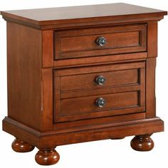 a wooden night stand with three drawers and two wheels on the bottom, against a white background