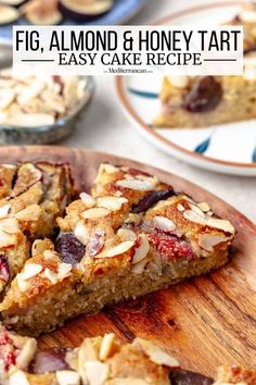 a wooden cutting board topped with slices of fruit and honey tart cake next to plates of desserts