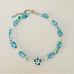 Blue Hawaii Tropical Beaded Necklace Handmade By Me And One Of A Kind! It Has Clear Beads And Loops Of Aqua Blue Tiny Beads. In The Middle Is A Beautiful Hibiscus Flower It’s A Short Necklace But The Length Can Be Adjusted To Wear It As A Choker As Well. Measures 14”-16” #Y2k #Coconutgirl #Surf #Tropical #Aesthetic Summer Blue Necklaces With Spacer Beads, Summer Blue Necklaces With Faceted Beads, Blue Beaded Flower Jewelry, Blue Flower-shaped Jewelry For The Beach, Blue Flower-shaped Jewelry With Beaded Chain, Blue Flower Jewelry For The Beach, Blue Bohemian Flower Beaded Necklaces, Blue Flower-shaped Beaded Jewelry, Summer Blue Beaded Necklaces With Faceted Beads