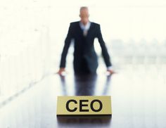 a business man standing in front of a desk with the word ceo written on it