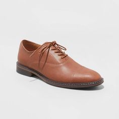 These Oxford Shoes from Goodfellow & Co™ are a closet staple, whether you're dressing for meetings or a family event. The pointed closed-toe shoes with a sleek upper with stitched detailing and a lace-up front are great for creating a sharp, stylish look. These medium-width shoes feature cushioned footbed construction for enhanced comfort and are great for both special occasion and everyday wear.

Goodfellow & Co™: Where style & fit are always in good company. Oxford Shoes Style, Chukka Sneakers, Oxford Dress Shoes, Oxford Shoes Men, Closed Toe Shoes, Oxford Dress, Family Event, Rubber Shoes, High Top Shoes