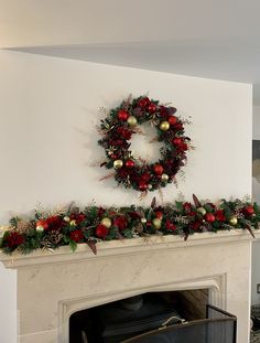 a fireplace with a wreath on the mantle