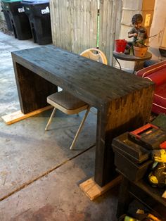 a wooden table sitting in the middle of a garage