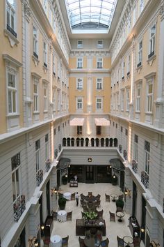 an atrium with tables and chairs in it