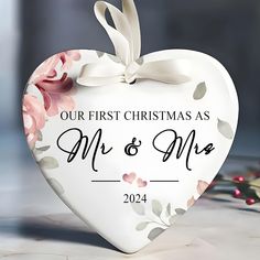 a heart shaped ornament that says our first christmas as mr and mrs