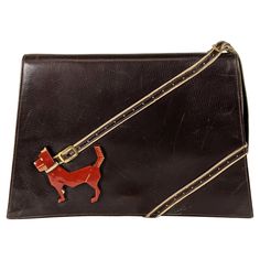 Rare Collectible High Art Deco Bakelite Dog Calf Leather Clutch from the 1930's by Virginia Bags. A carved and patinaed futurist bakelite dog is anchored by a perforated leather leash which becomes the handle at the top of the bag. 1930's. 9" x 6" x 1.5". Handle 4.5". Art Deco Bag, New York Fits, Devil Wears Prada, Gorgeous Clothes, Estilo Art Deco, High Art, Perforated Leather, Purse Accessories, Old Art