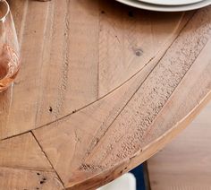 a wooden table with plates and glasses on it