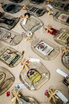 several glass bottles with labels on them are sitting on a tablecloth covered table cloth